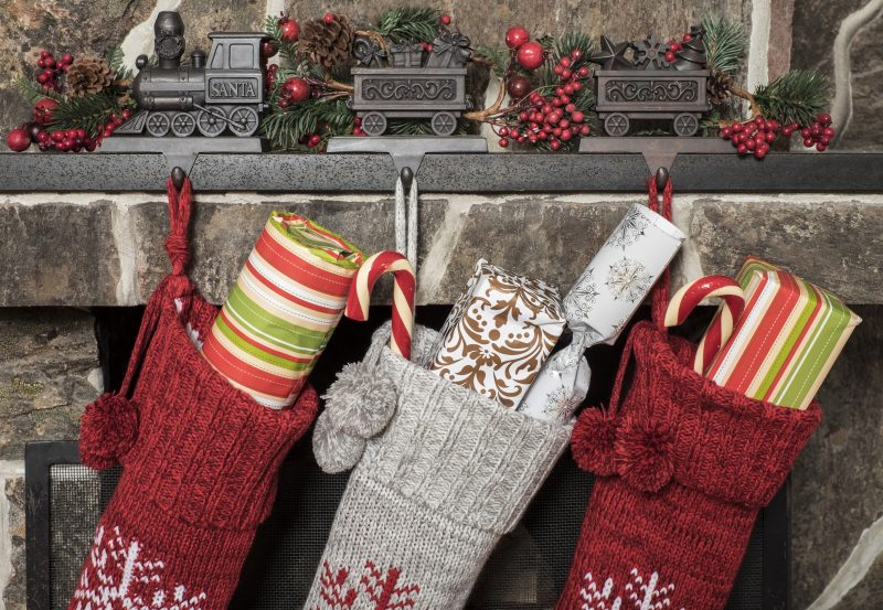Stuffed stockings hanging on a fireplace on christmas morning